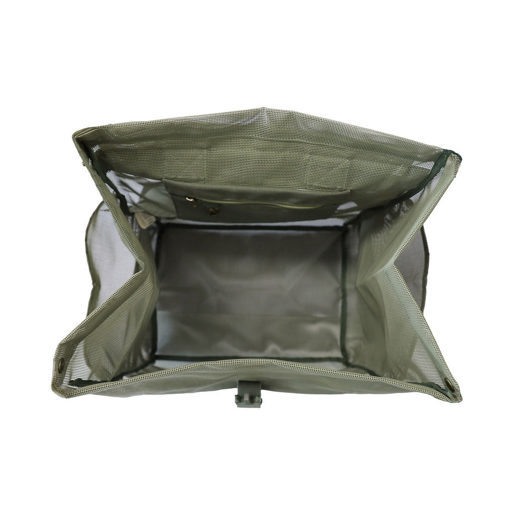 A studio image of the Sande Kids™ Beach Hauler mesh backpack in Pandanus Green, shown from the top to highlight its practical internal design. This view showcases the internal canvas pocket with a key clip and a large internal mesh pocket, perfect for organizing beach essentials. The backpack’s durable mesh fabric is an ideal choice for beach trips and outdoor adventures. Set against a white background, this functional design ensures convenience.