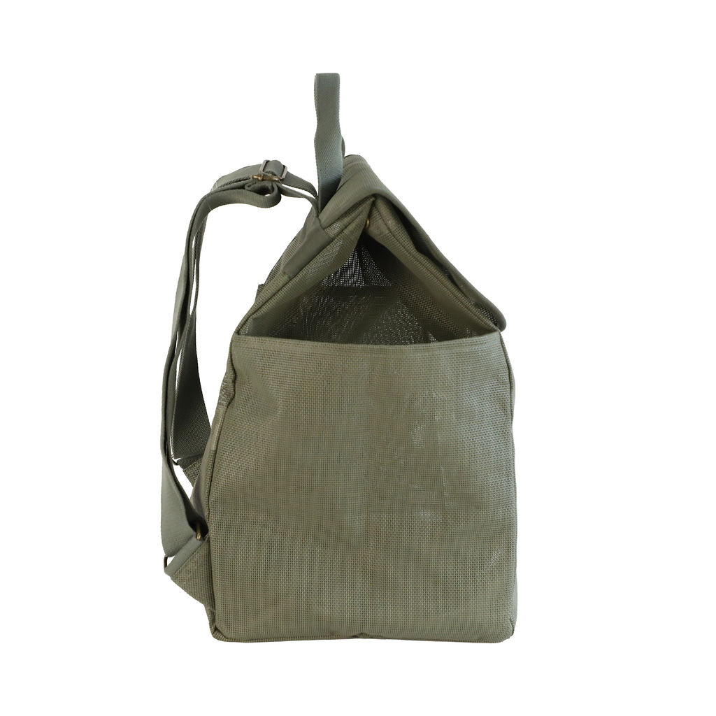 A studio image of the Sande Kids™ Beach Hauler mesh backpack in Pandanus Green, shown from the side to highlight its spacious design and practical features. This side view emphasizes the large side mesh pockets, adjustable straps, and the handle at the top. The backpack is set against a white background, showcasing its durability and ideal design for beach trips and outdoor adventures.