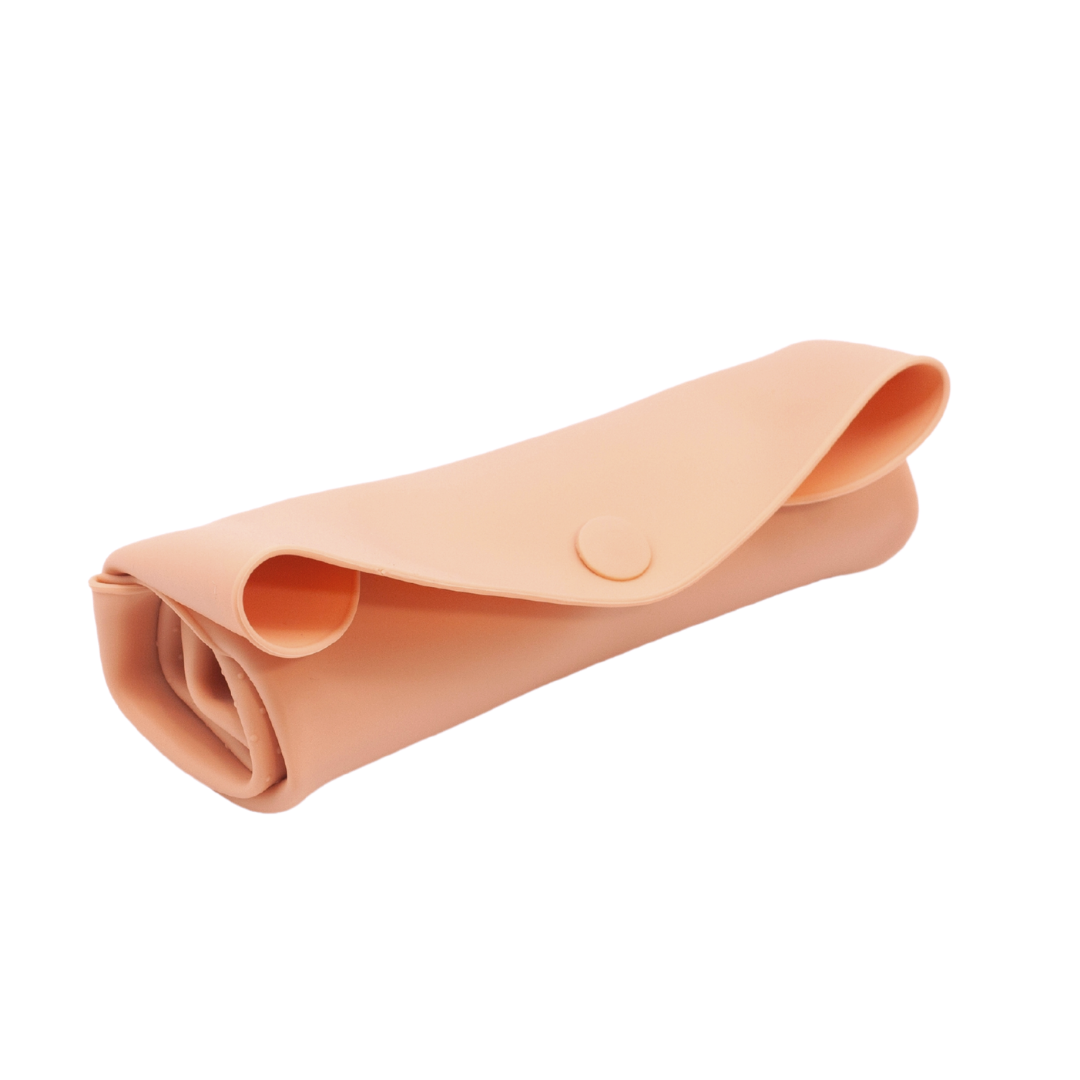 The Sande Kids™ waterproof car seat and pram liner in Coral Pink is rolled and secured with a silicone button. This studio image, set against a white background, highlights the compact, space-saving design of the liner for easy storage.