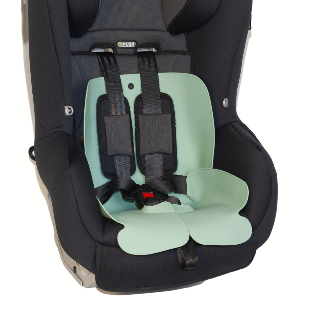 The Sande Kids™ waterproof car seat and pram liner in Seafoam Green is shown in a harnessed forward-facing car seat.