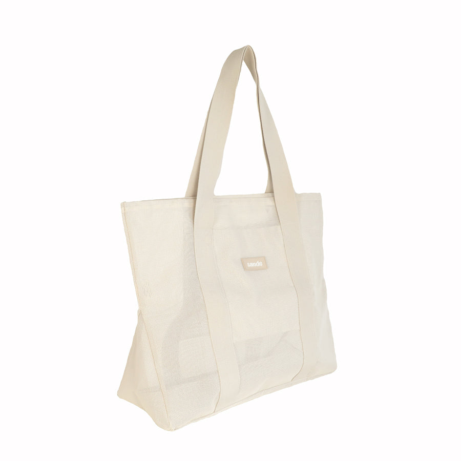 Side view of the Sande™ Beach Hauler -Mini mesh beach bag in Sand/Neutral on a white background, showcasing its spacious interior, breathable sand-free mesh fabric, and durable, family-friendly sand-free design for beach trips and outdoor adventures.