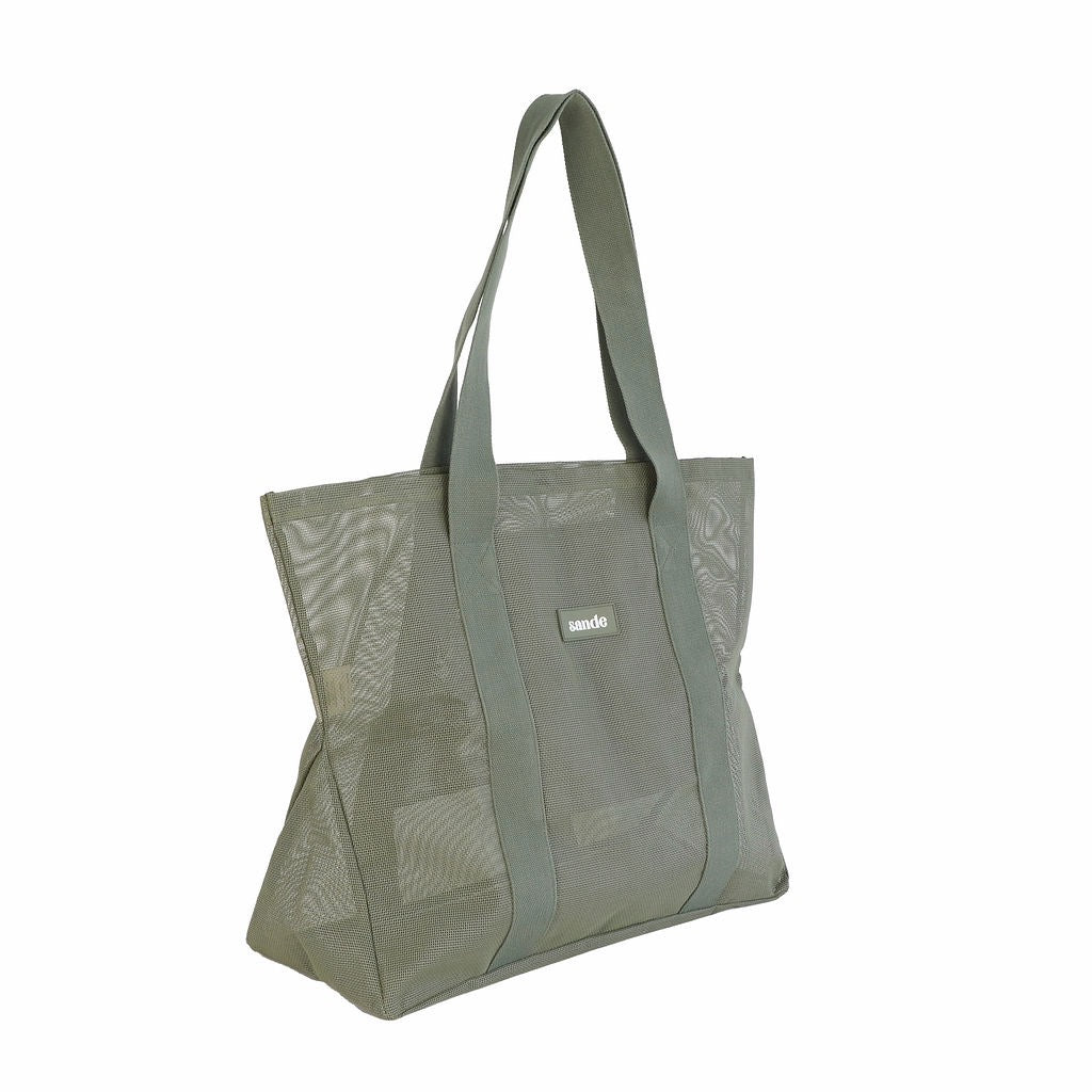Side view of Sande Kids Beach Hauler Mini mesh beach bag in Pandanus green, shown on a white background, highlighting its large design and durable mesh material.