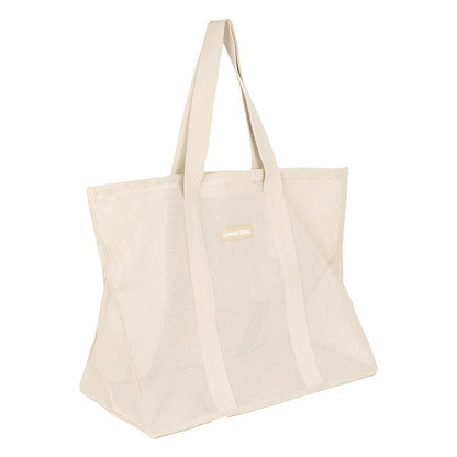 Side view of the Sande Kids original oversized mesh beach bag in neutral.