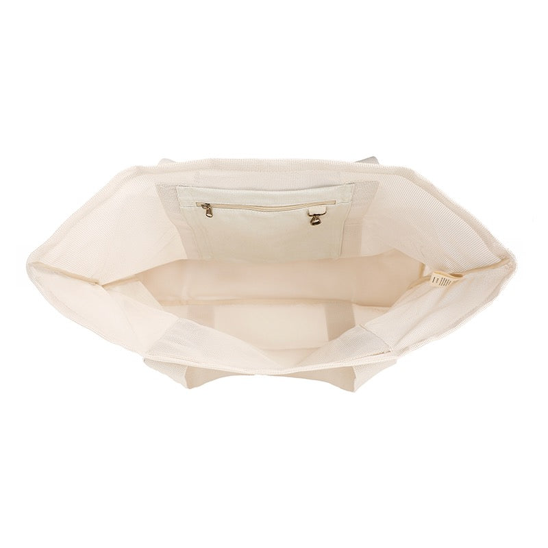 Top view of Sande Kids™ original Beach Hauler mesh bag in Sand Dune, highlighting spacious internal pockets and durable design, ideal for organizing beach essentials. Product on white background.