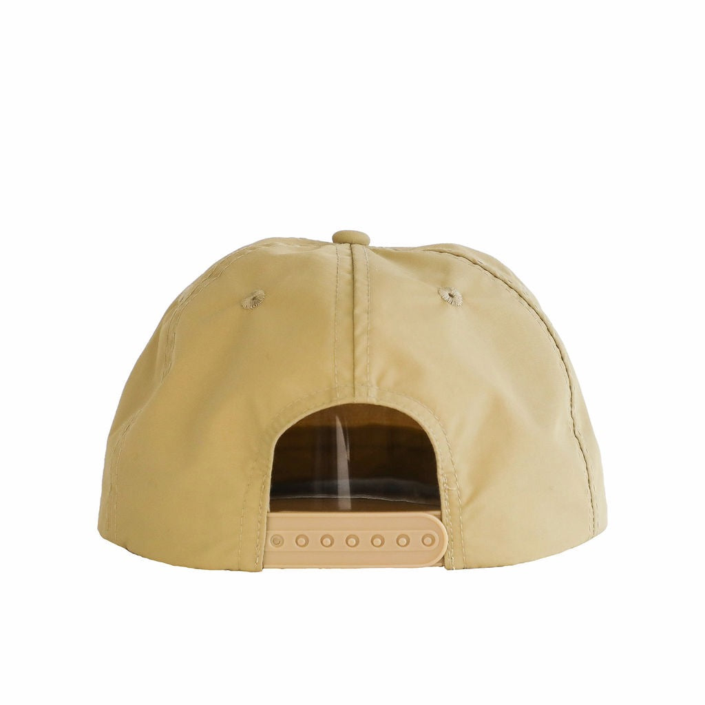 A beige cap made from waterproof nylon fabric, shown from the rear. The cap features a plastic snapback and the Sande Kids™ logo embroidered in white on the front.