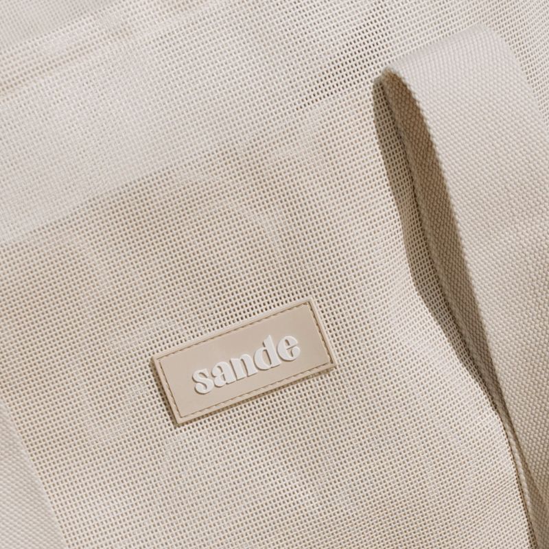 Sande Kids Beach Hauler™ beach bag featuring durable neutral PVC mesh fabric and thick cotton webbing strap in neutral, designed for optimal comfort and style for beach trips and family adventures.