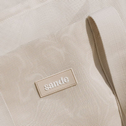 Sande Kids Beach Hauler™ beach bag featuring durable neutral PVC mesh fabric and thick cotton webbing strap in neutral, designed for optimal comfort and style for beach trips and family adventures.