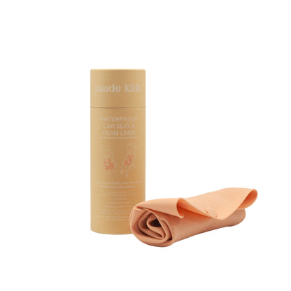 Kraft Cylinder packaging for the Sande Kids™ Waterproof Car Seat and Pram Liner. Liner shown in Coral Pink.